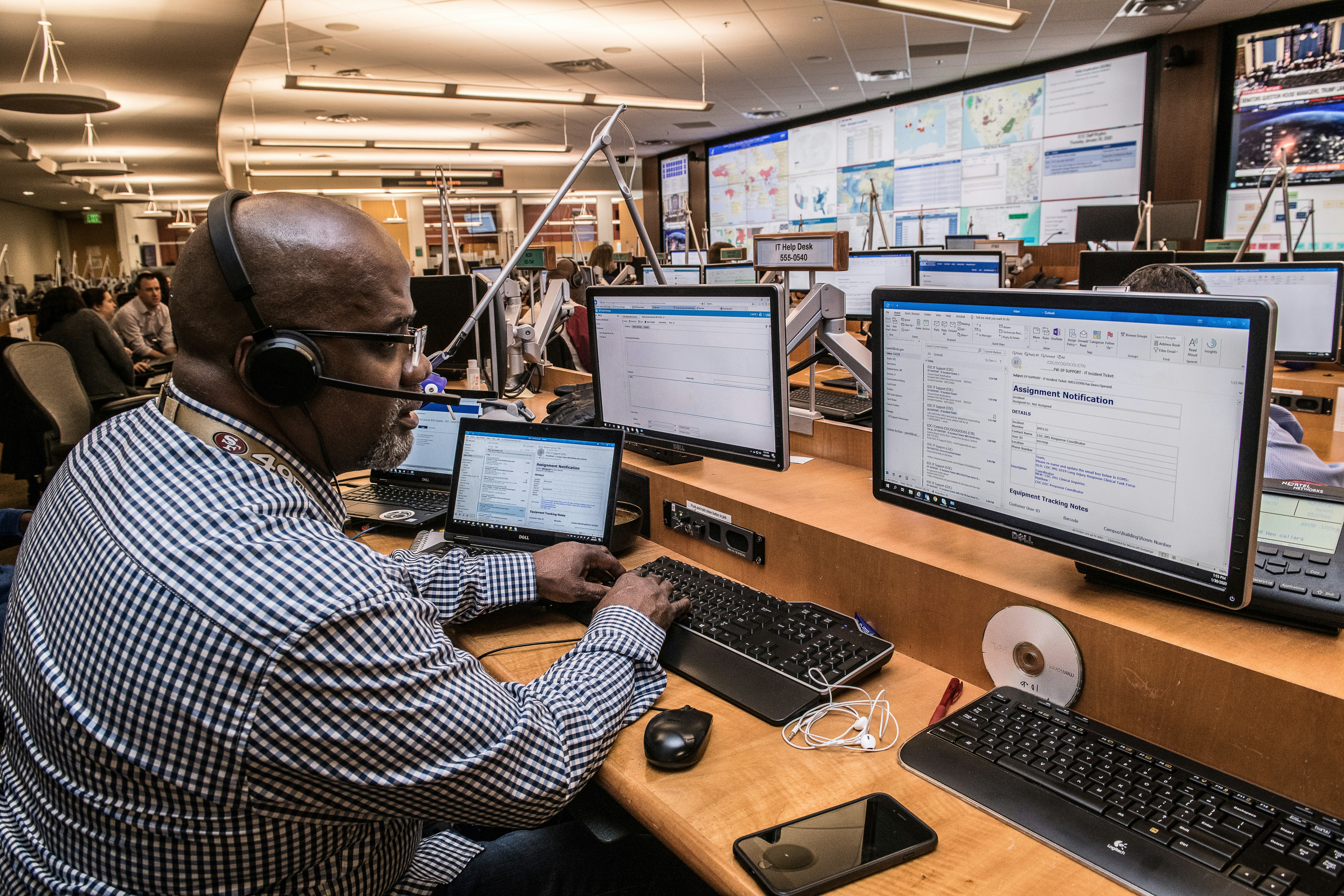 Man working in his computer and taking a call at the same time